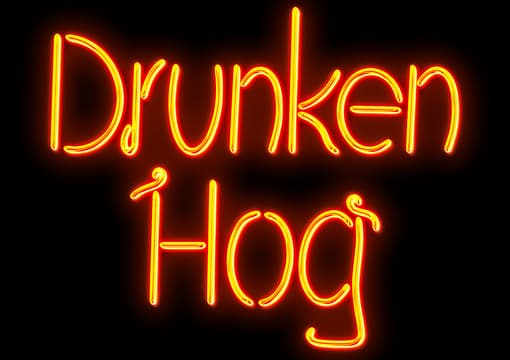 Drunken Hog: glowing neon script with tube-like strokes and warm outer halo glow.