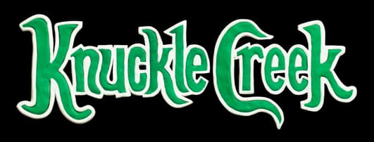 Knuckle Creek: Green medieval serif lettering with thick white outline and shadow.