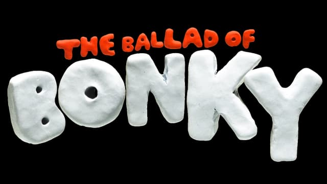 Rounded, clay-like letters with pronounced texture and playful 3D effect.