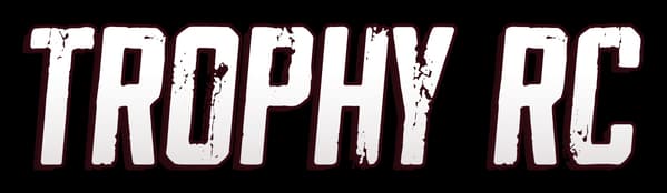 TrophyRC: Bold distressed block letters with thick dark outline and wide spacing.