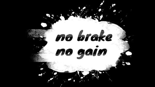 Brush script font with a splattered paint look, tire track and grunge effects.