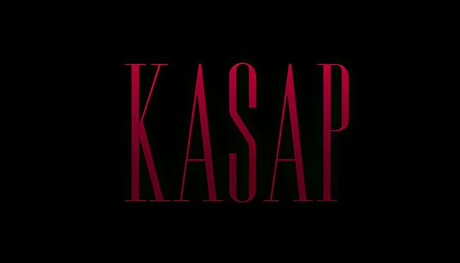 KASAP: Red title text over a dark butcher shop interior with shadowy walls, hanging meat hooks, and framed photos.