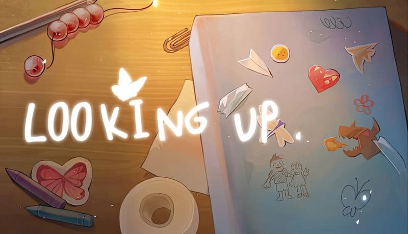 Looking Up: A cluttered desk with stickers, paper dragons, markers, and candies illuminated by a soft, warm light.