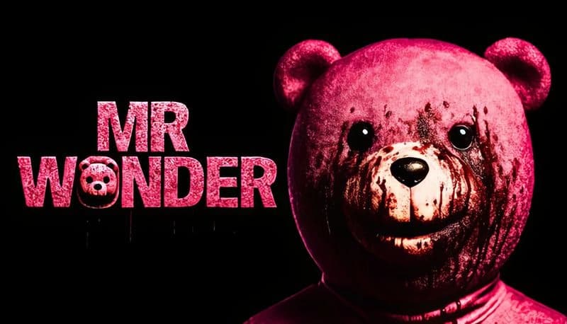 Mr Wonder: Pink teddy bear with blood-stained face, black backdrop, beady eyes wide open, standing beside game logo.