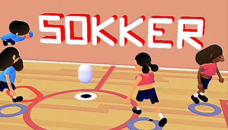 Sokker: Four young players, two in red and two in blue, chase a soccer ball on an indoor court with wooden flooring.