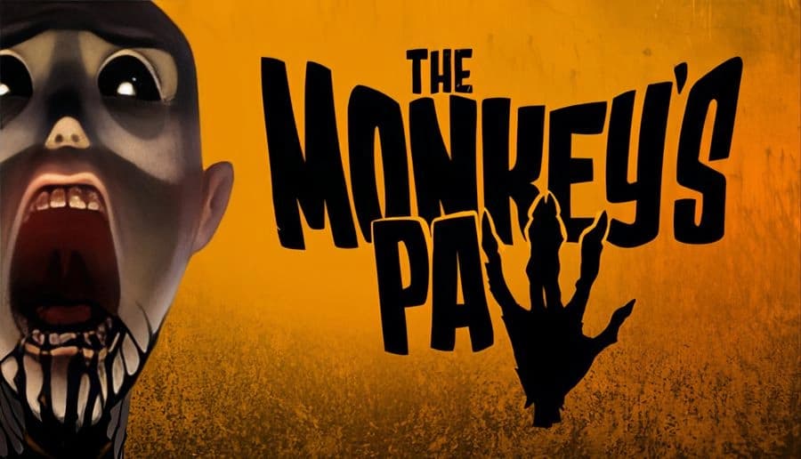 The Monkey’s Paw: screaming pale face with black eye sockets, open mouth and teeth on a mustard backdrop.