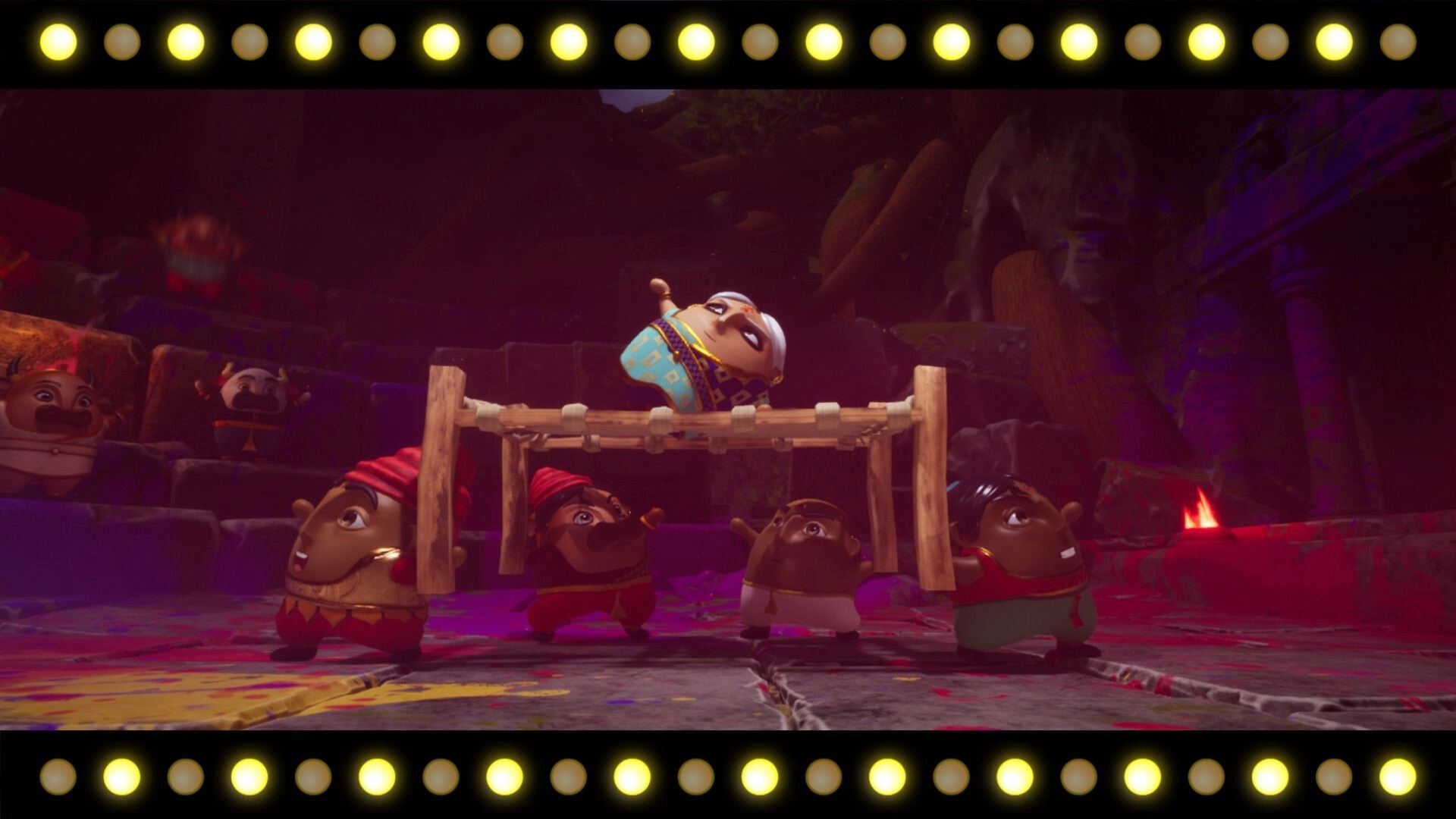 Aikyam: Animated villagers perform a dance with vibrant costumes on a colorful stage surrounded by lights.