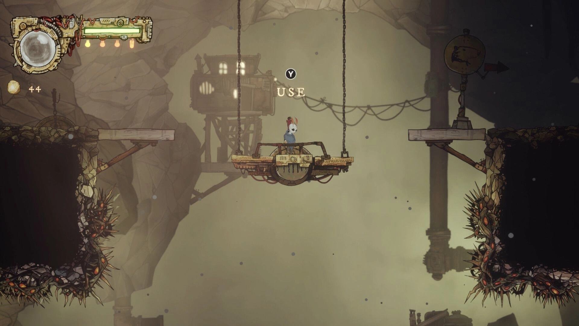 Cliff Kingdom: Mothboy stands on a hanging platform with Y USE prompt in a foggy cavern above spikes.