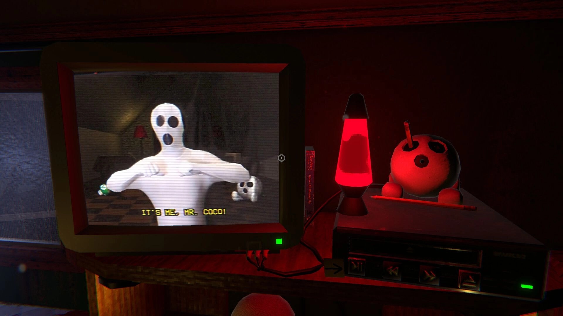 COCOBOY: CRT TV plays “It’s me, Mr. Coco!” beside red lava lamp and bowling ball on VCR shelf.