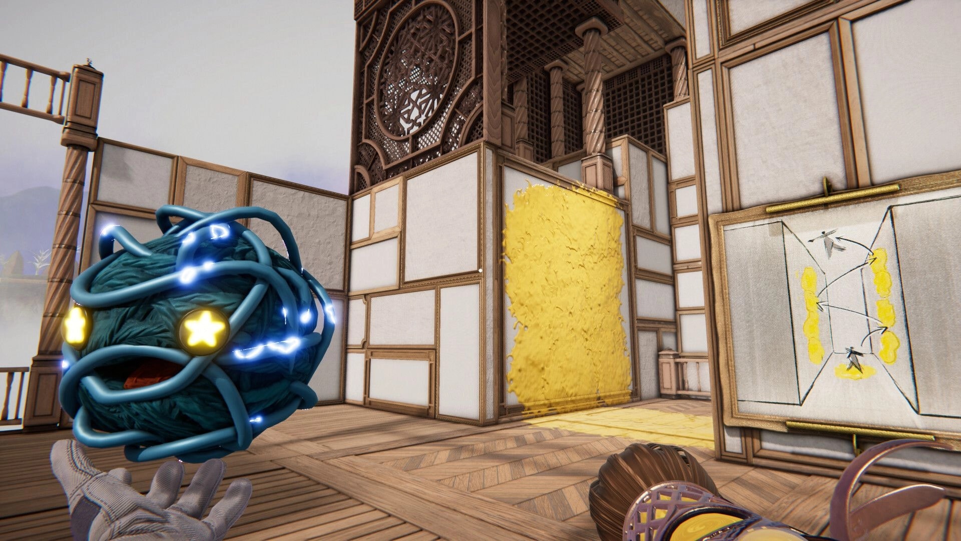 Dreampainters: Holding a glowing orb near a yellow paint wall puzzle in a wooden art studio room.