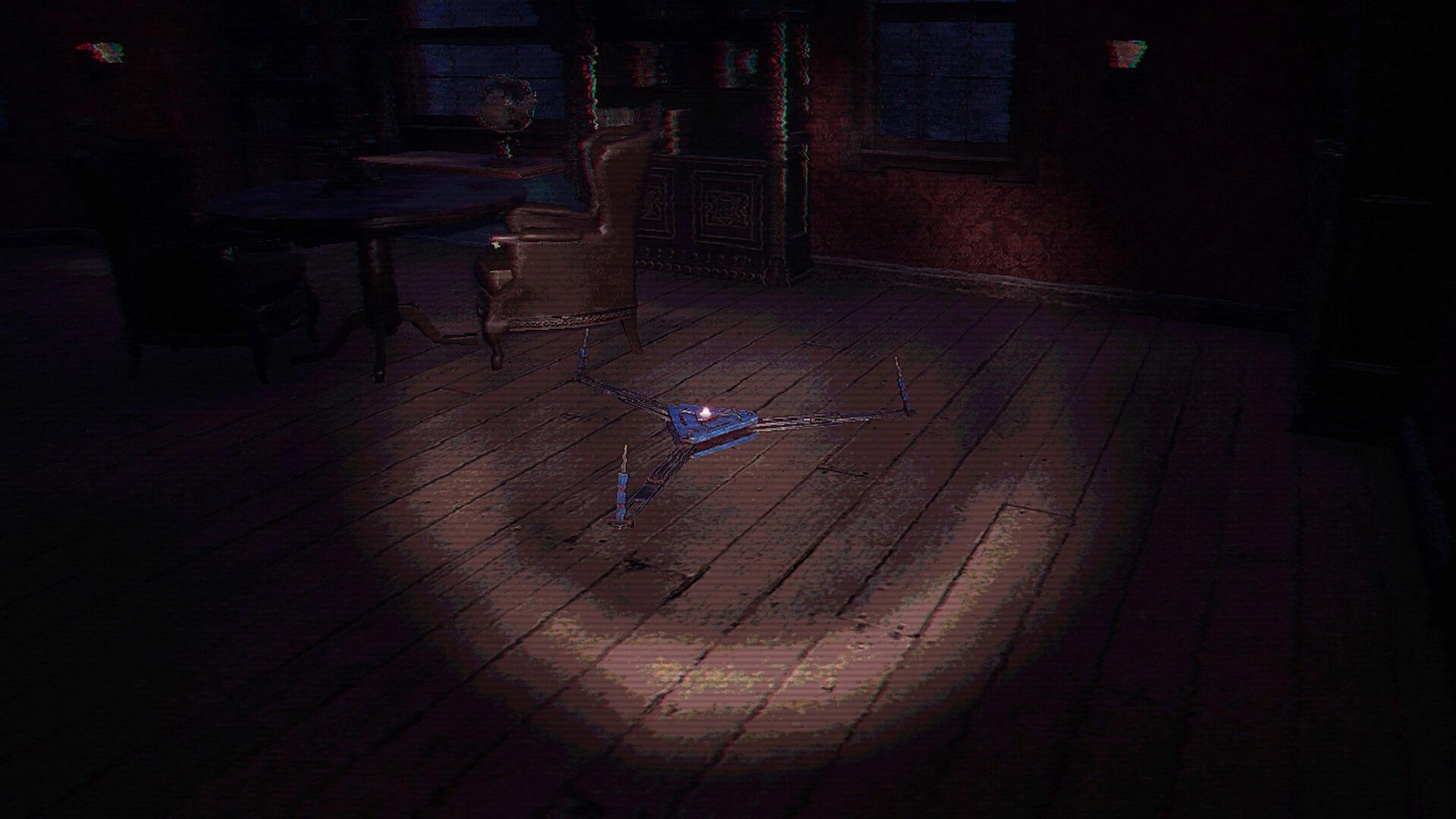 Ghost Scout: Tripod ghost detector on wooden floor in a dark room with table and shuttered windows.