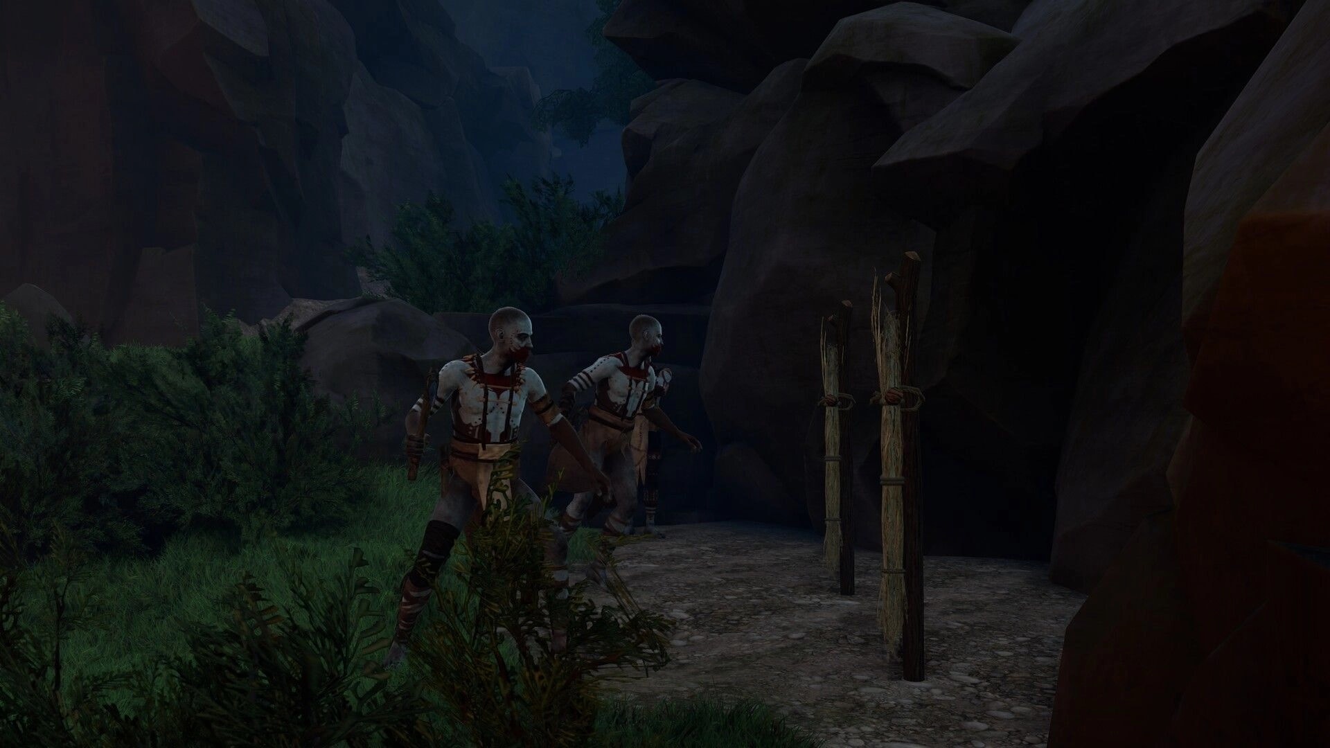 Kiipluu: Two hostile hunters patrol past wooden stakes beside a rocky canyon path at dusk.