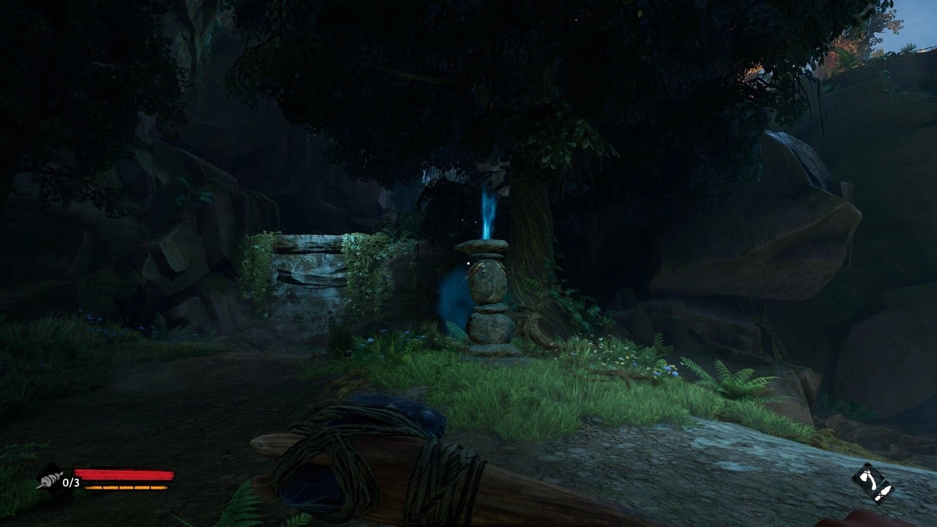 Kiipluu: First-person view of a blue-glowing stone cairn marker in a shadowy forest path clearing.