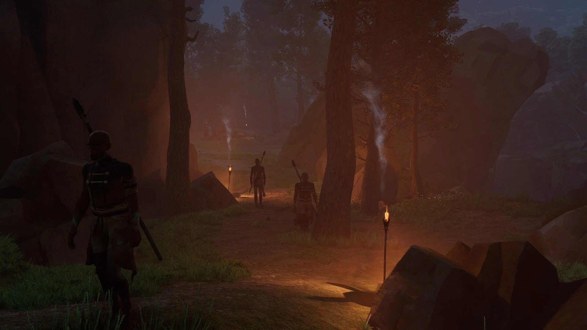 Kiipluu: Three spear-wielding figures patrol a torchlit trail through a misty forest canyon at dusk.