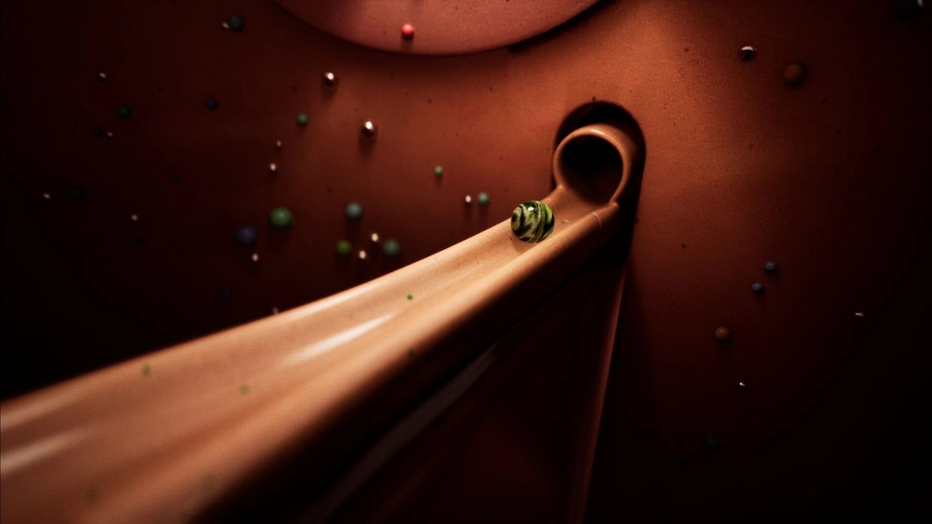 Marblearium: Green marble rolling down a curved copper chute toward a tunnel in a giant bowl run.