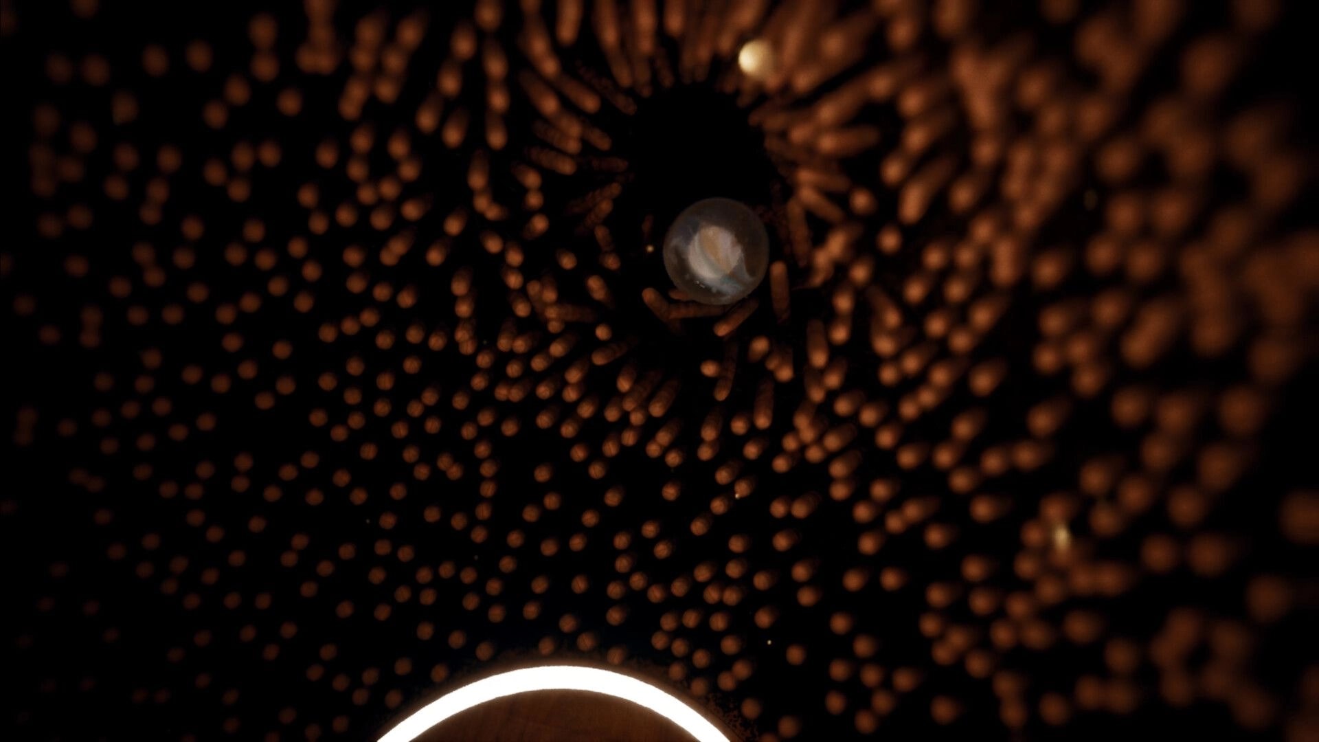 Marblearium: Marble drifting through a dark tunnel of glowing orange dots in a swirling void backdrop.