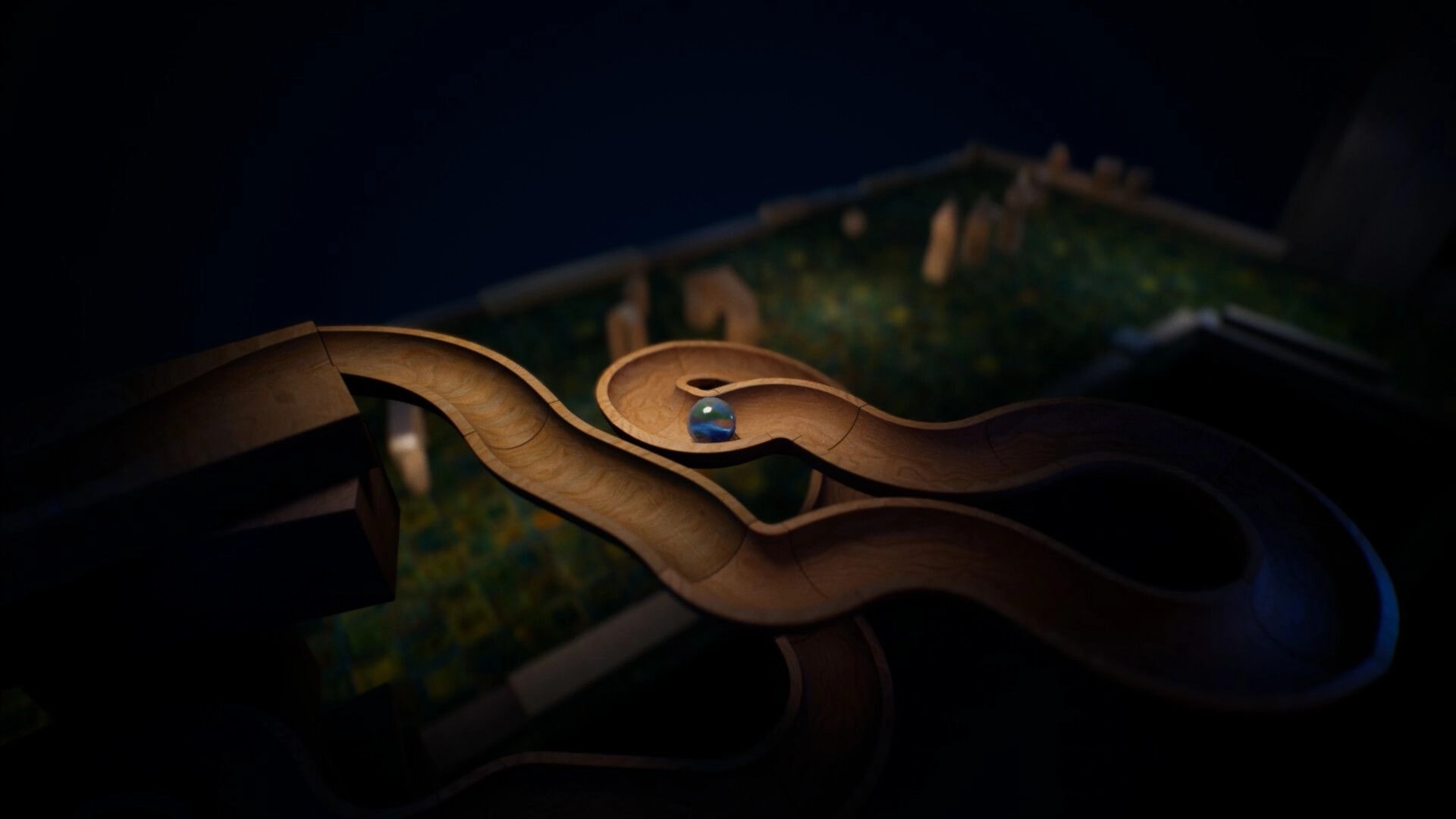 Marblearium: Blue marble rolling through curving wooden track above a blurred grassy diorama scene.