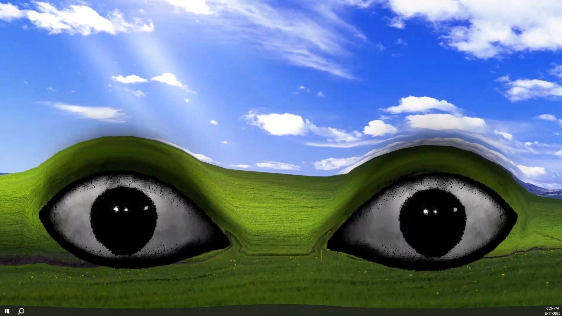 My Helpers: Giant staring eyes embedded in grassy hills under a bright blue sky desktop backdrop.