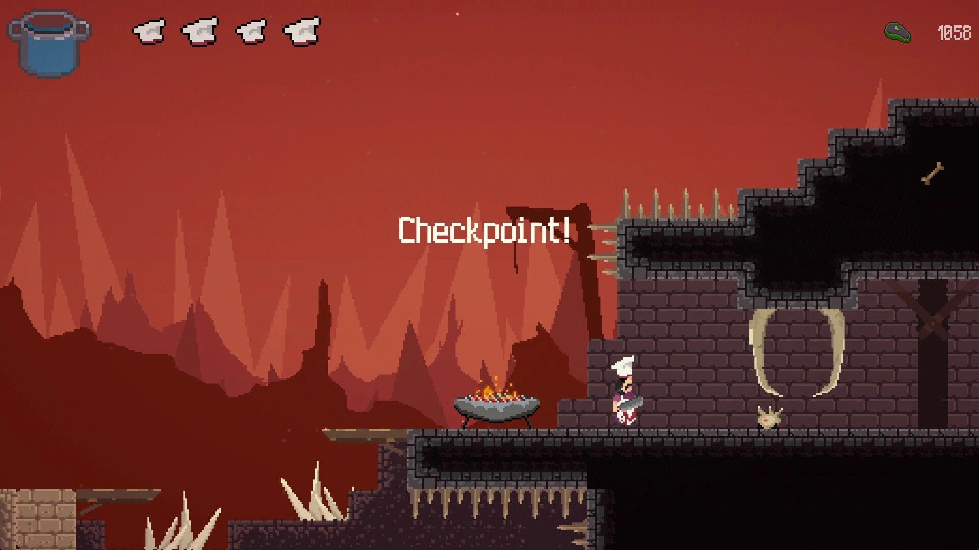 Pablo’s Journey: Checkpoint reached by chef hero beside a brazier in a spiky brick cavern level.