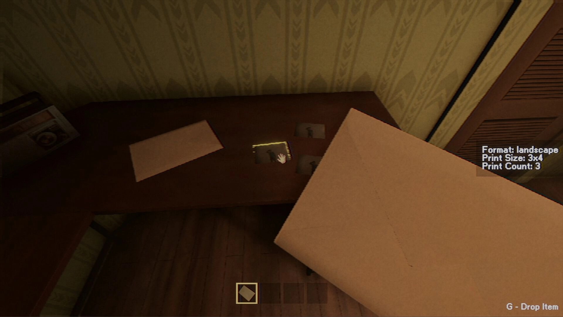 Photomaly: Holding a photo envelope over a desk with prints, UI lists format, size 3x4, count 3.