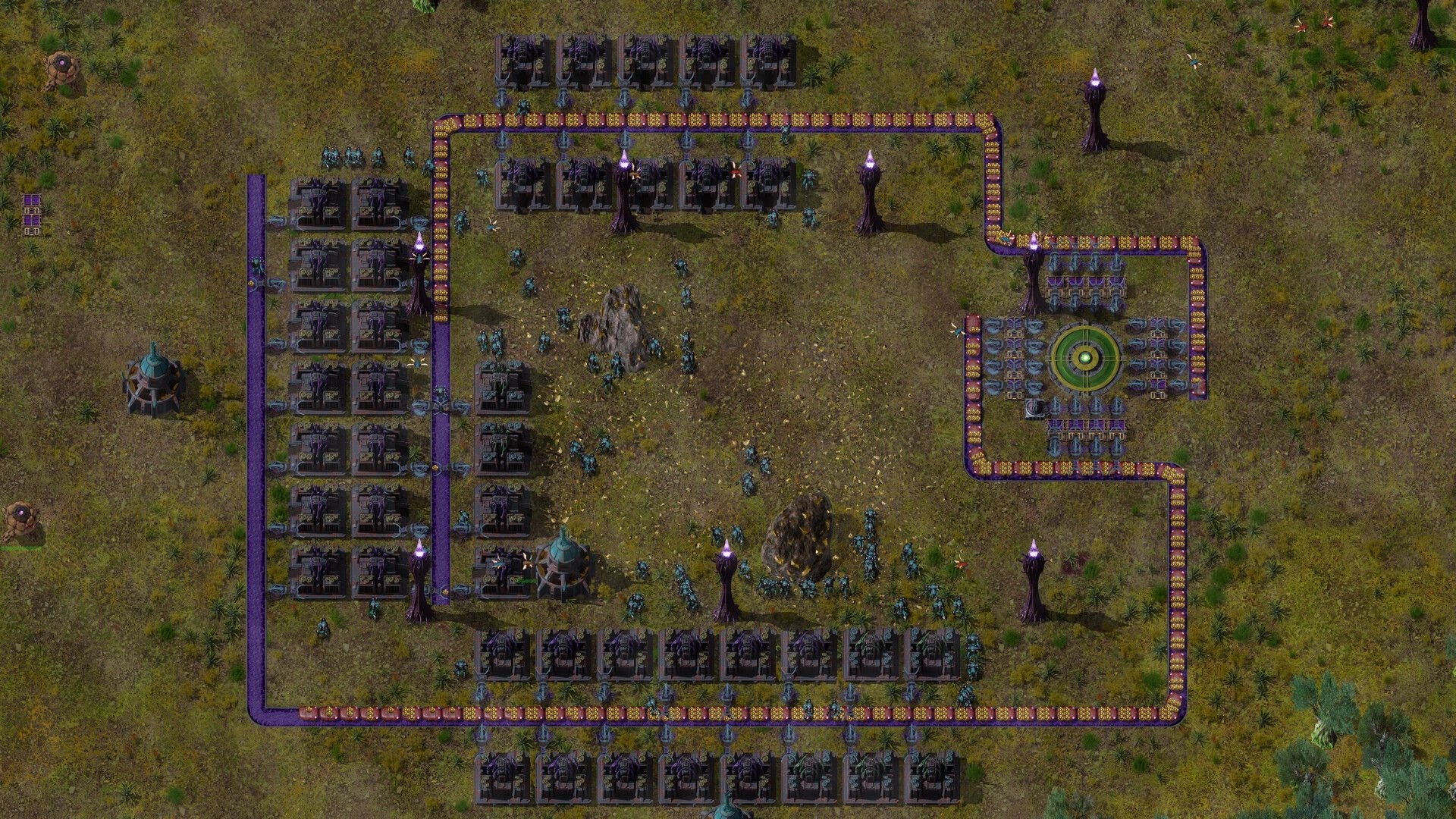 Swarmdustry: Conveyor loop feeds a green core hub past factories and purple pylons on grassland base.