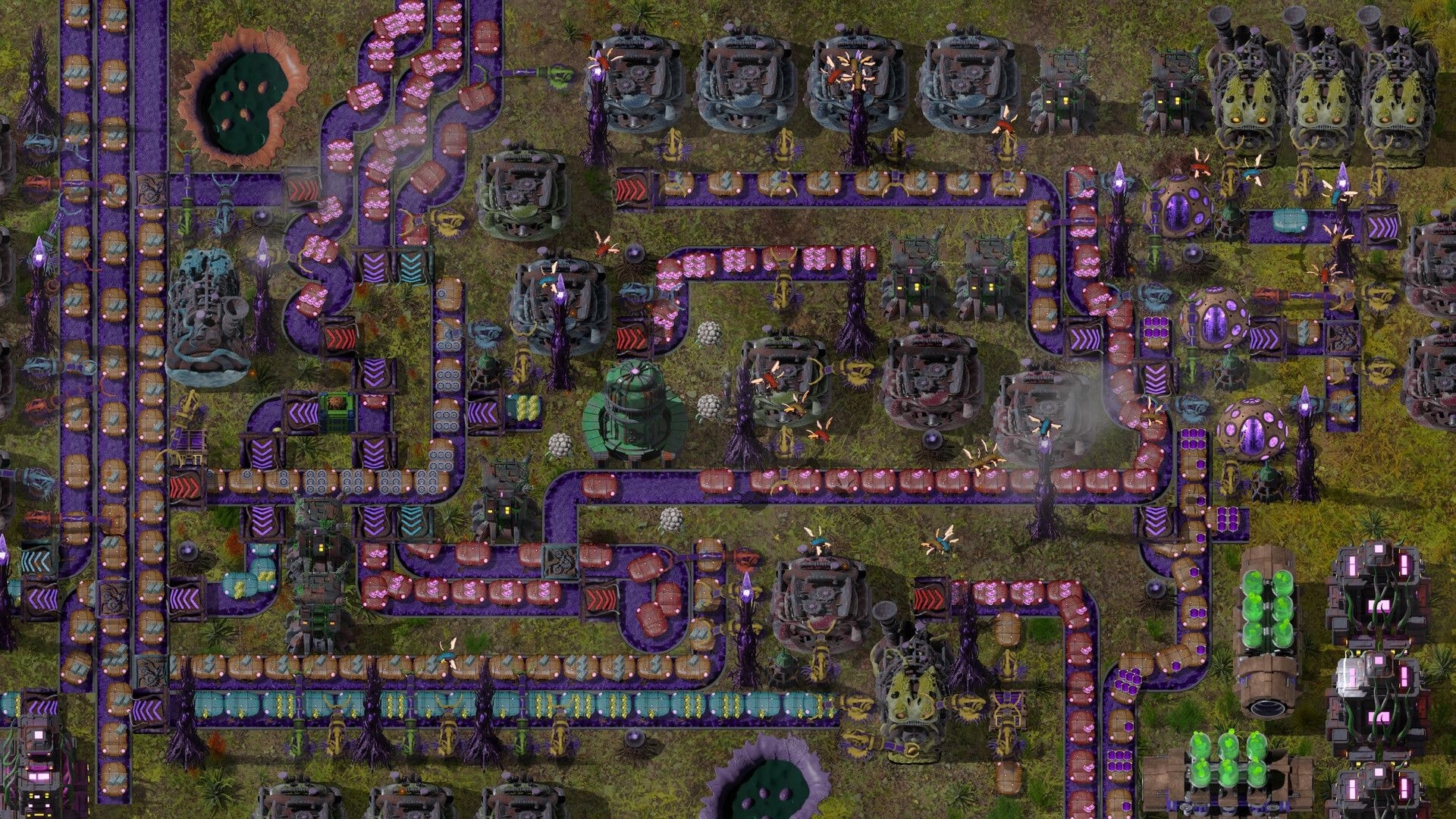 Swarmdustry: Conveyor belts route pink biomass between machines and pods across a dense base grid.