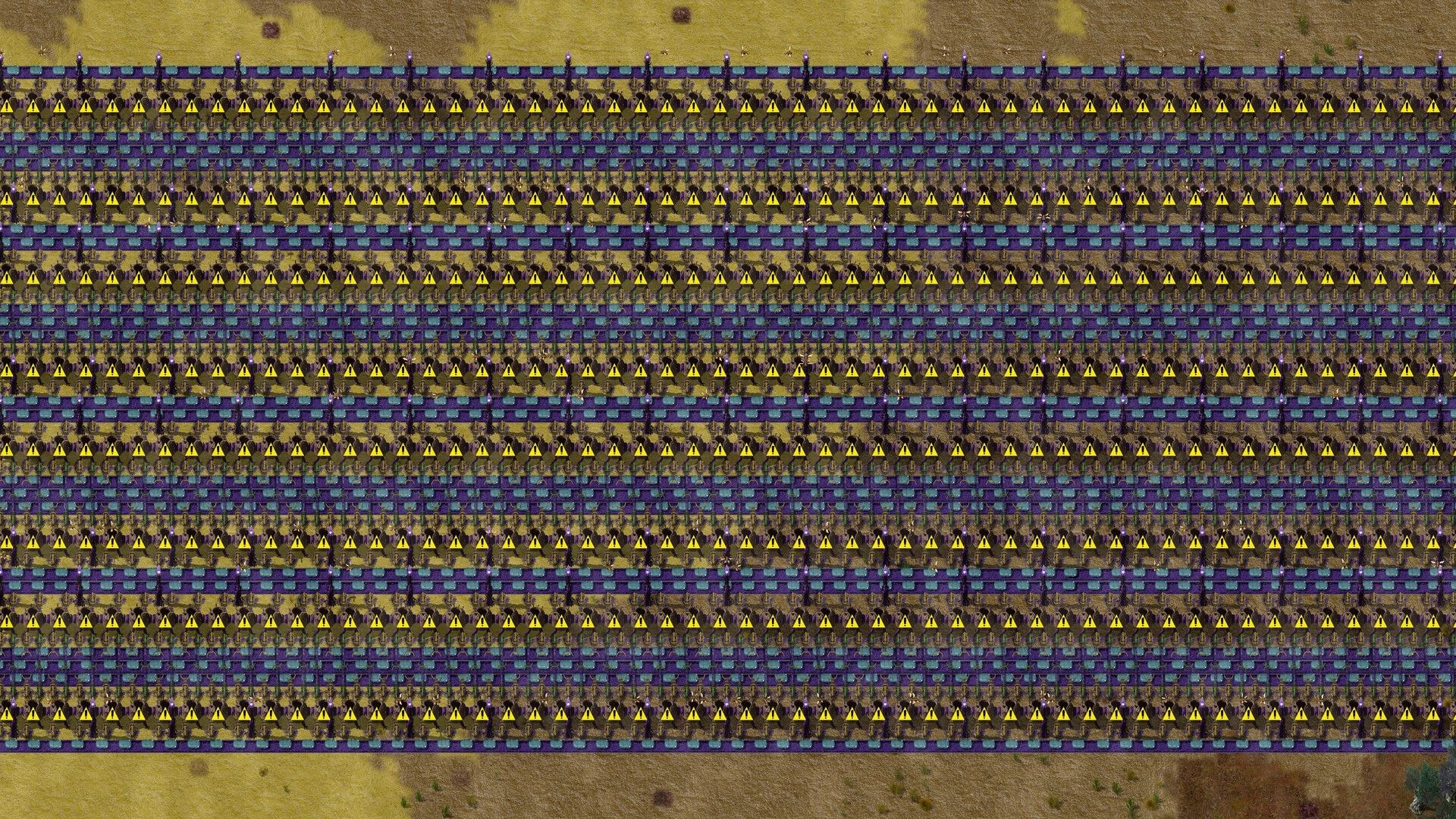 Swarmdustry: Massive grid of conveyor belts and hazard warning icons across a sandy industrial field.