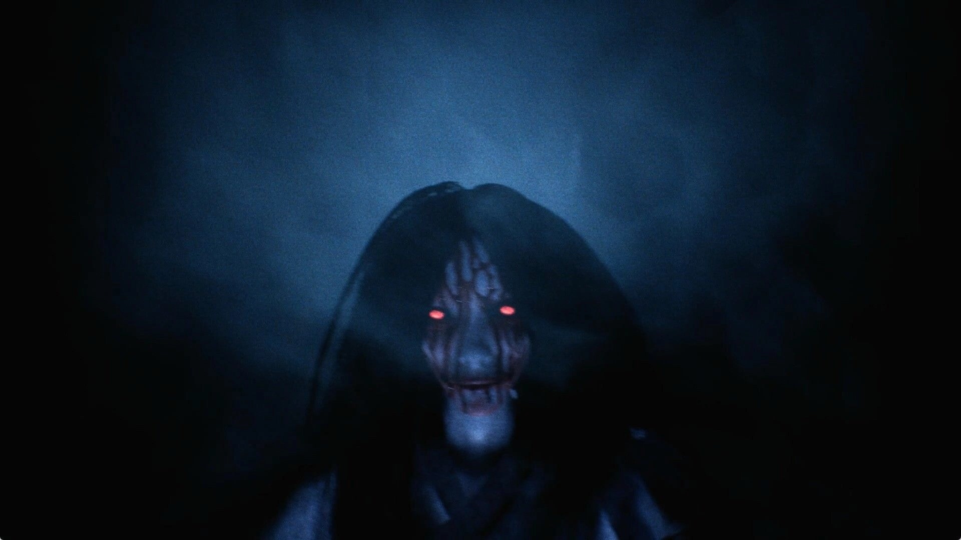 The Alley: Close-up of a bloodied ghost face with glowing red eyes in a dark, foggy view.