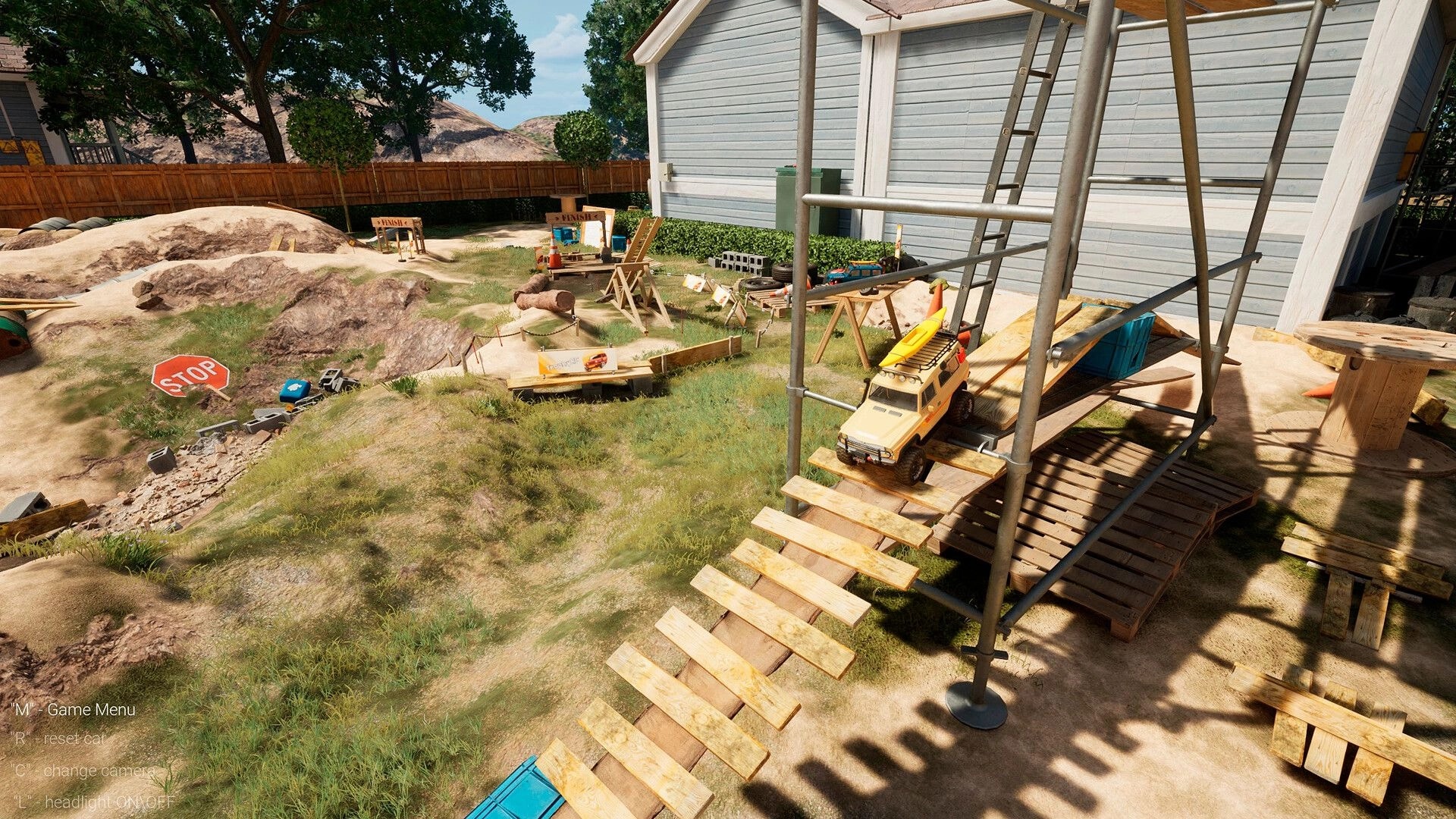 TrophyRC: RC crawler perched on scaffolding ramp in backyard obstacle course beside house and rocks.