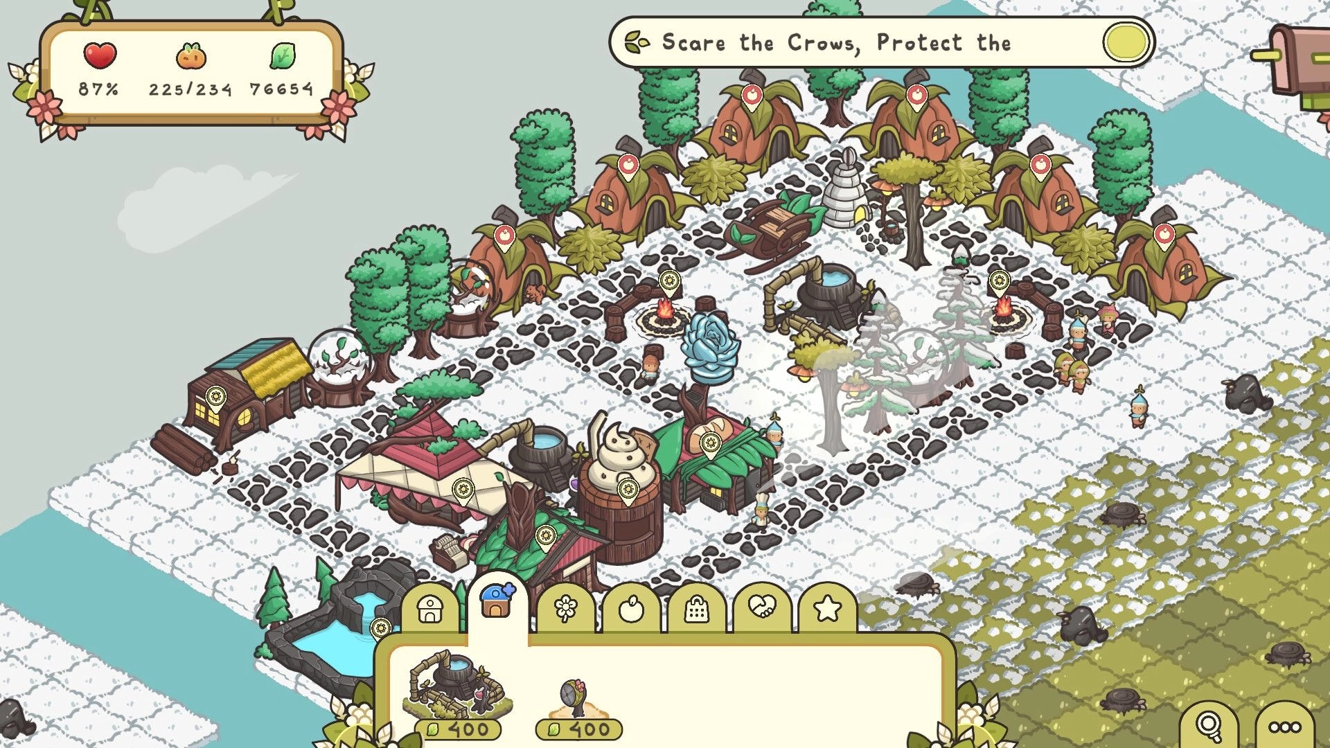 Verde: Snowy town overview with seedlet huts, campfires, and build menu icons along bottom UI.