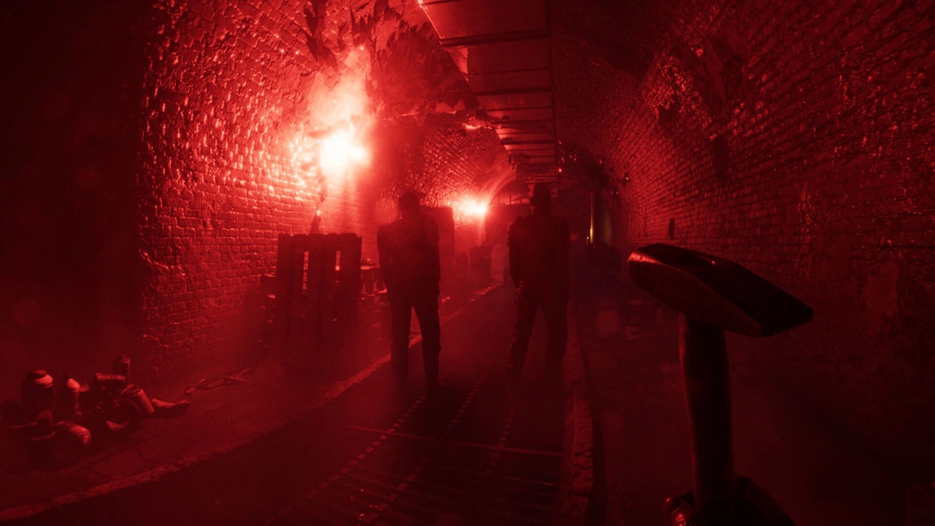 A.A.U. Black Site: Two agents stand in dimly lit, red-tinged underground tunnel with scattered crates.