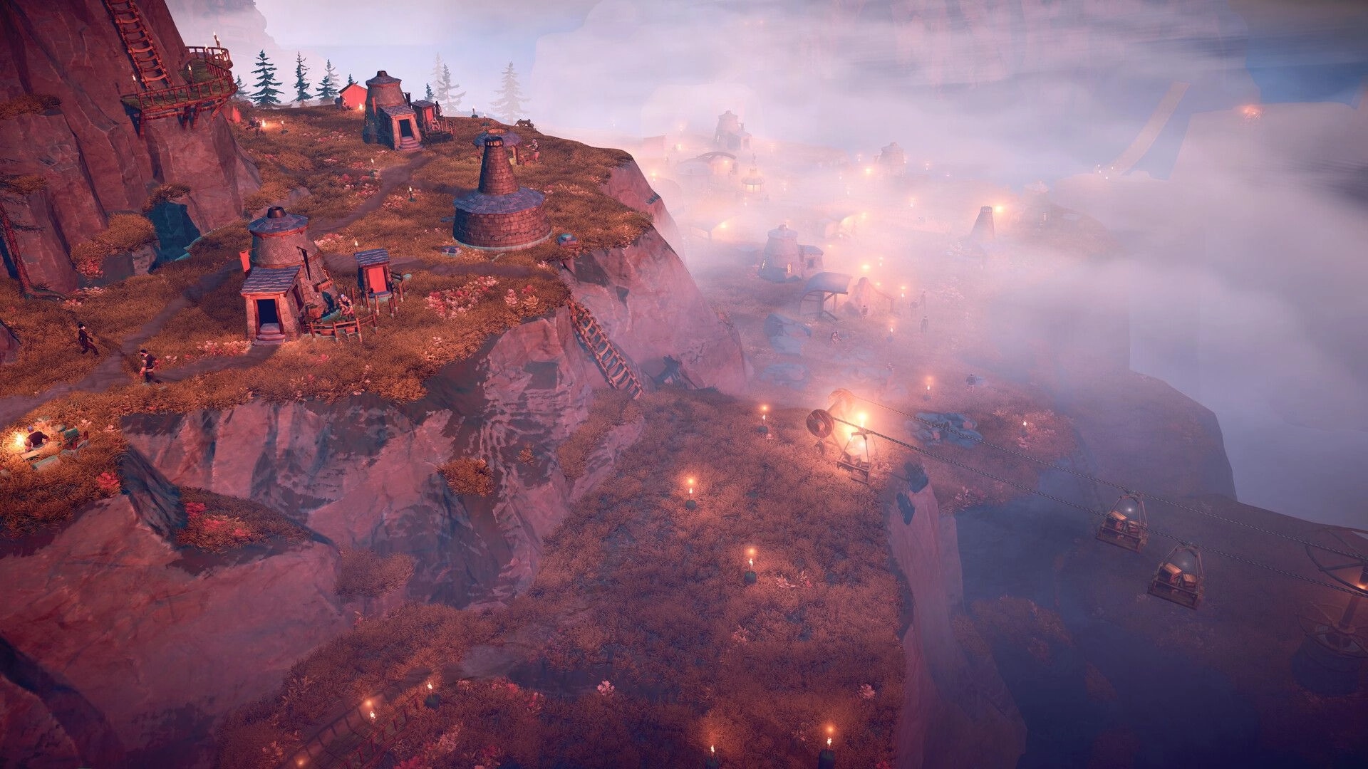 Above: Hilltop colony buildings and torchlit paths on cliffs above a foggy valley with cable cars.