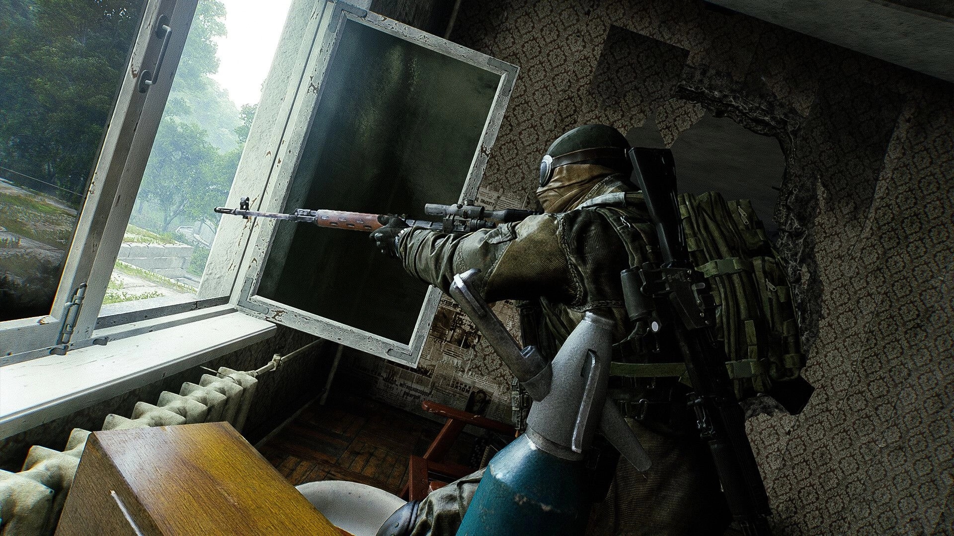 Active Matter: Soldier aiming rifle through broken window in abandoned building overlooking forest terrain