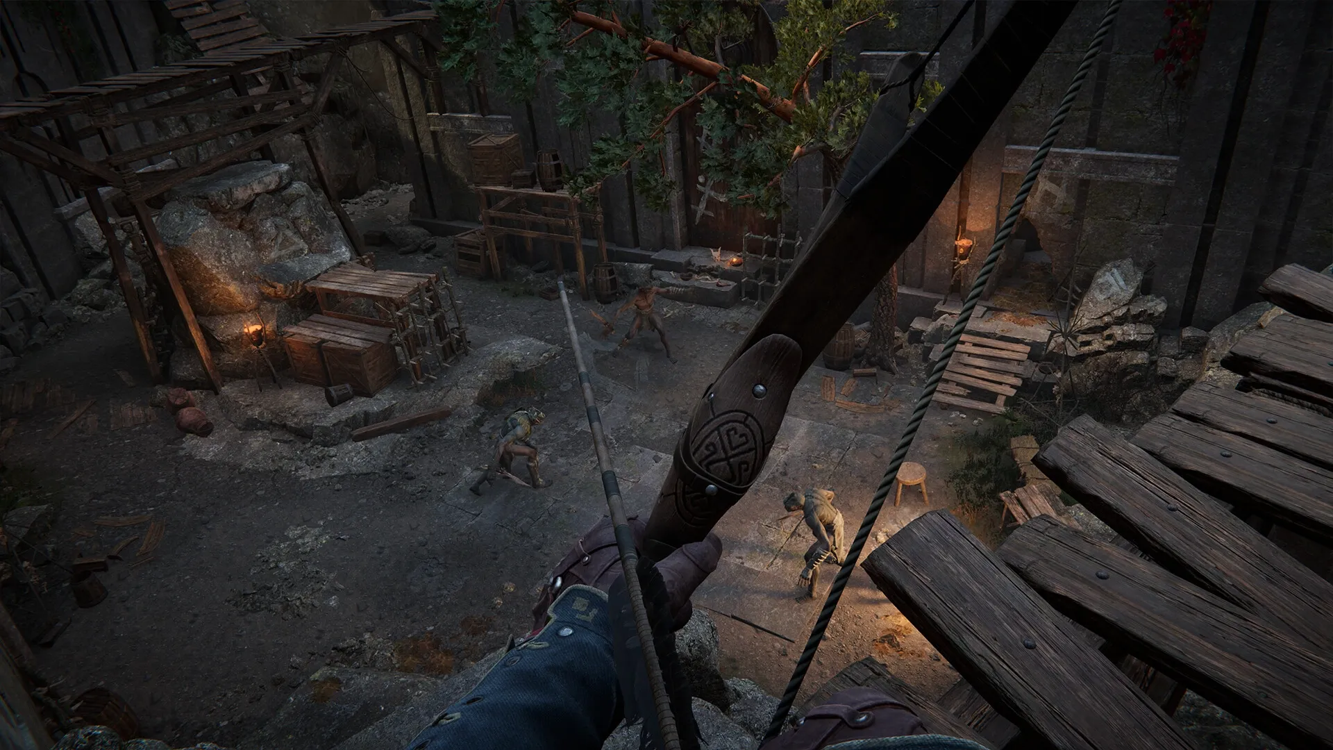 Alkahest: Aiming a bow at enemies in a dim medieval courtyard filled with wooden structures and crates.