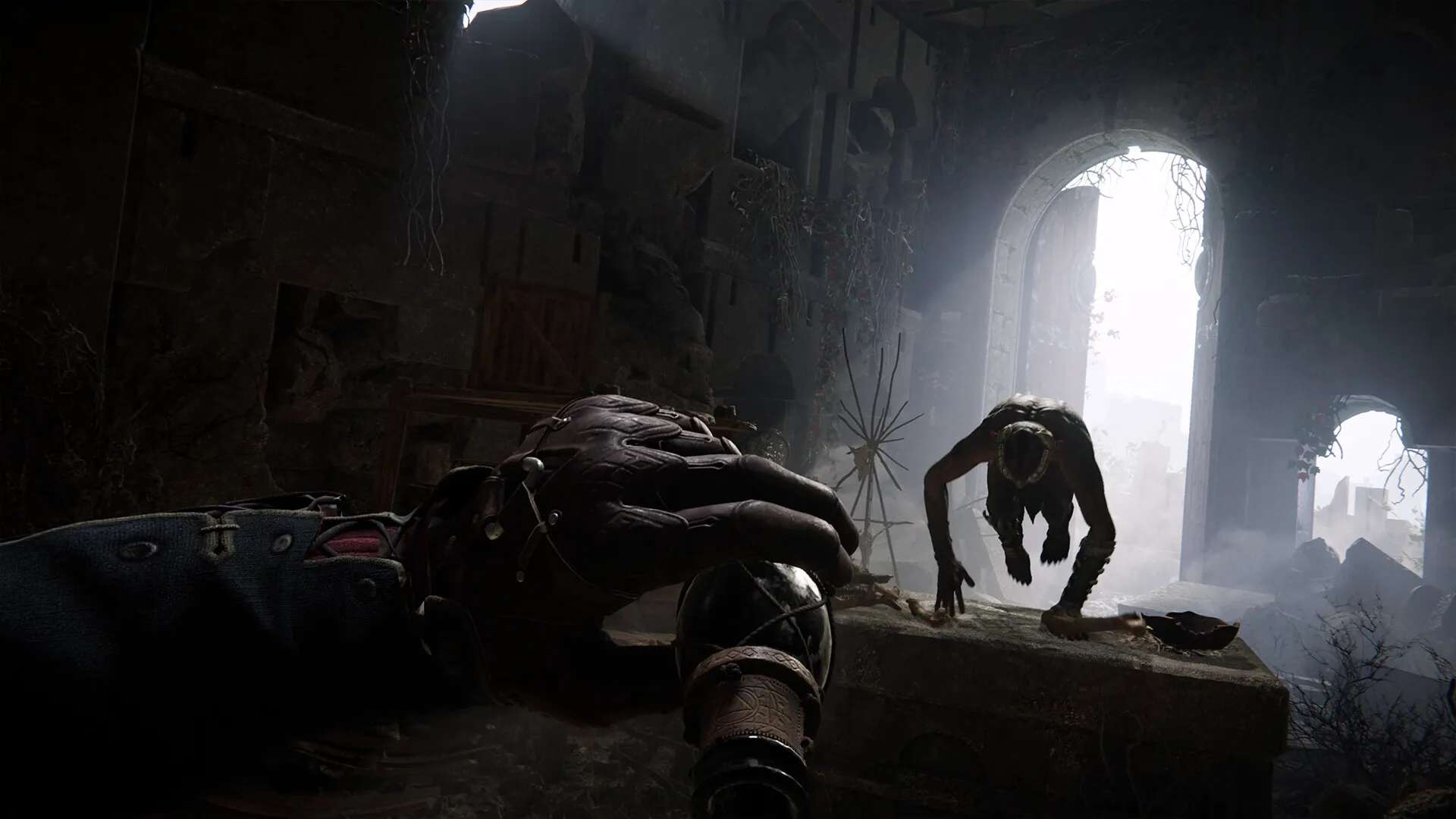 Alkahest: Player aiming alchemical device at charging creature in a dimly lit, crumbling stone ruin.