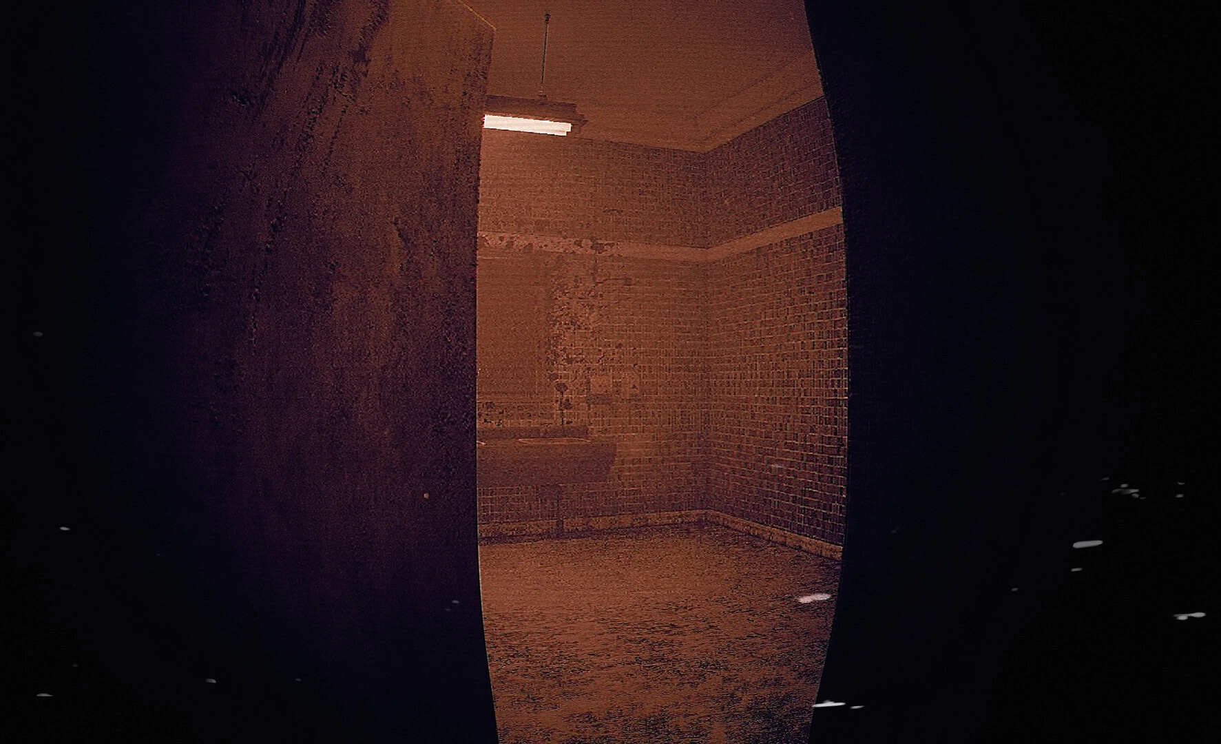 ALONE: First-person view peeking into a grimy tiled shower room lit by a flickering ceiling lamp.