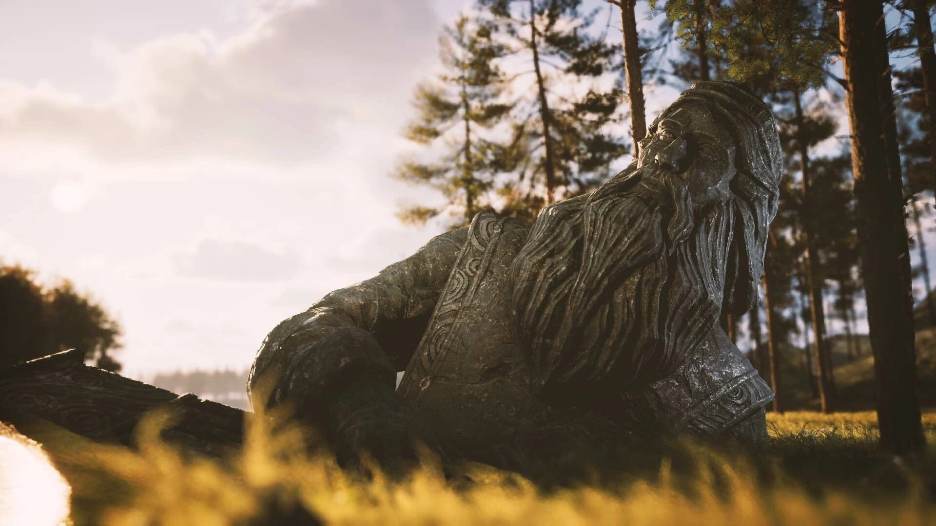 Among the Trolls: Stone statue of a reclining bearded figure surrounded by trees in a sunlit forest