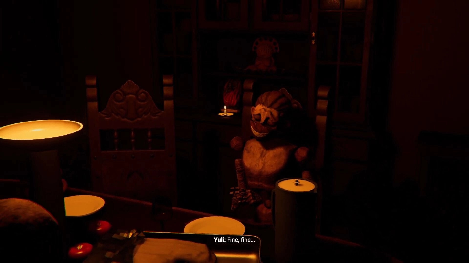 Animas Prologue: Yuli seated with eerie doll in dimly lit dining room with candles and food