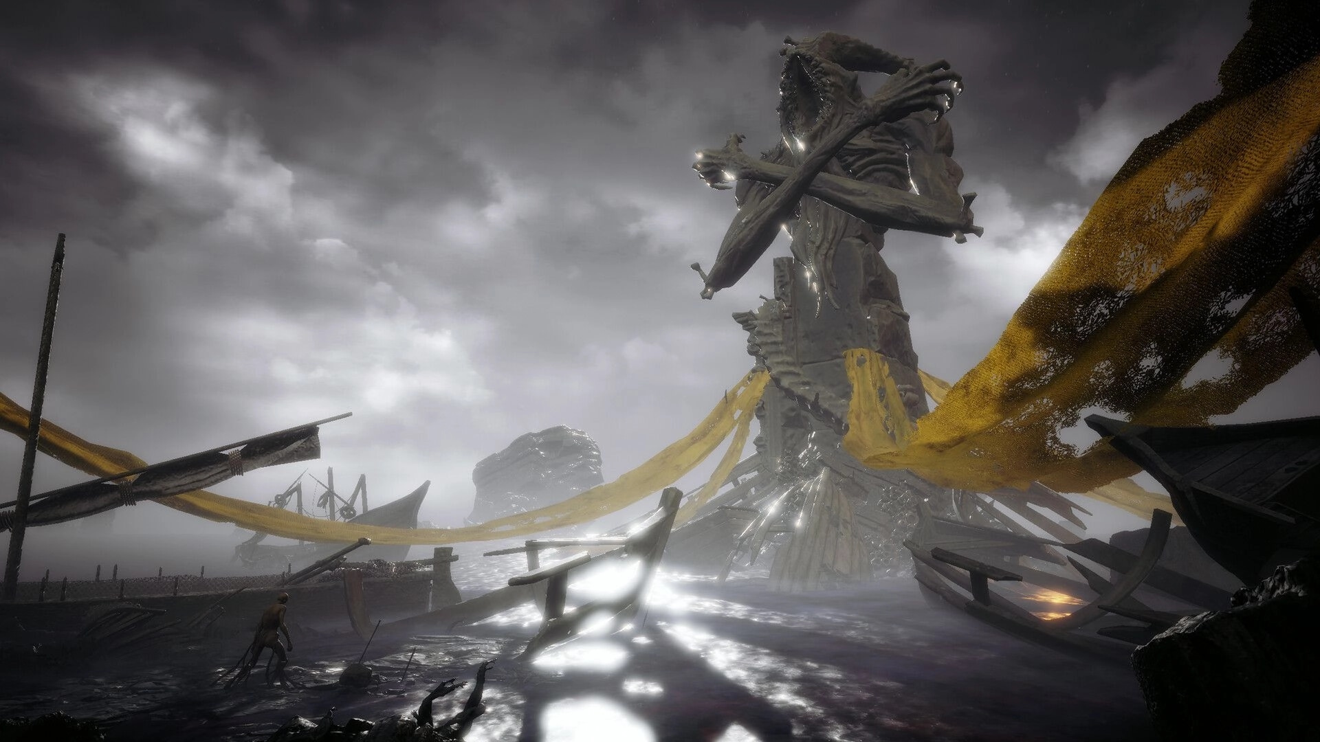 Annulus: Lone figure explores desolate shore under massive, decaying statue with yellow tattered banners
