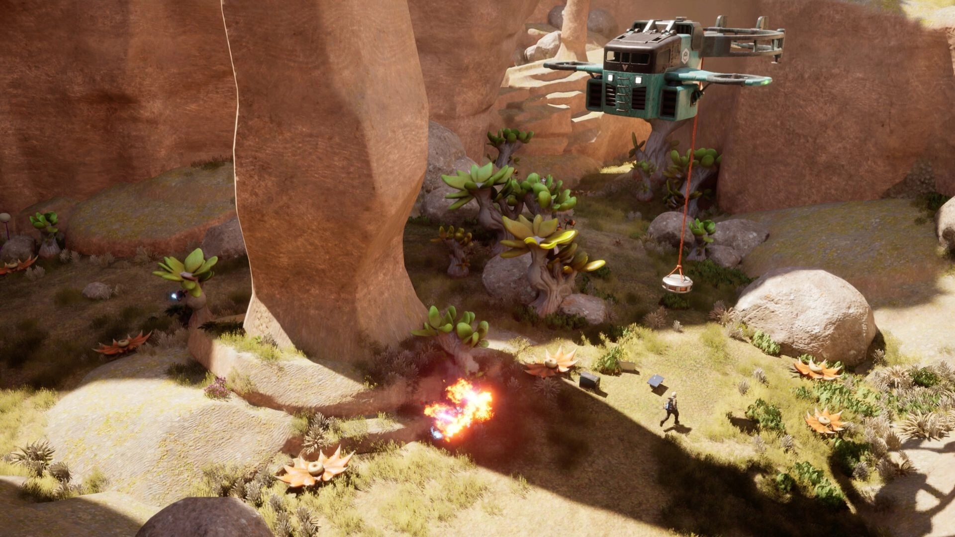 ATMOSFAR: Player runs past an explosion as a hovering drone lifts cargo in a rocky canyon grove.