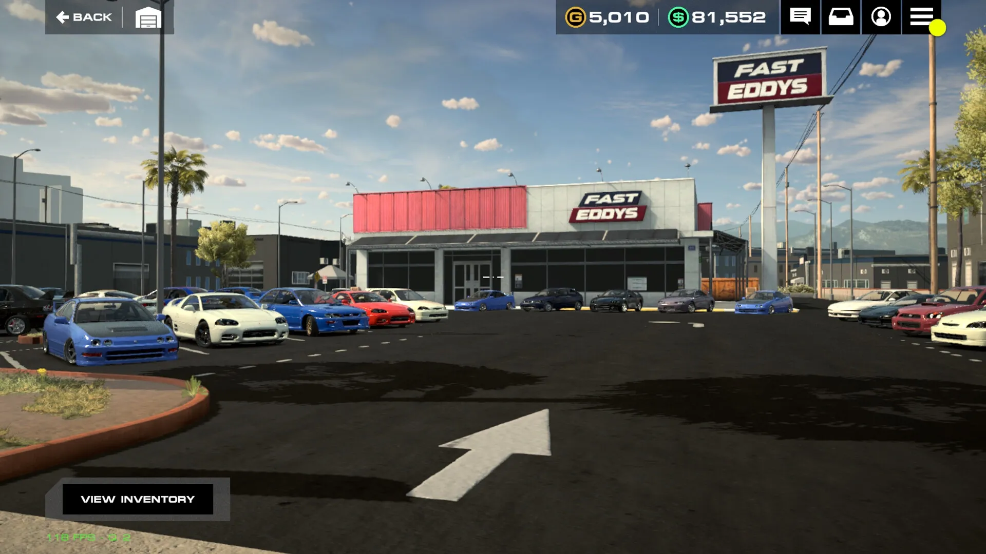 Auto Legends: Car dealership lot with various parked cars and Fast Eddys building in the background