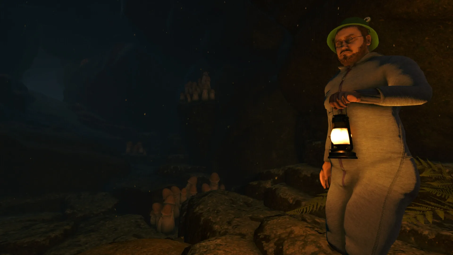 Baby Steps: Nate explores a dark cave holding a lantern, surrounded by rocks and mysterious formations.
