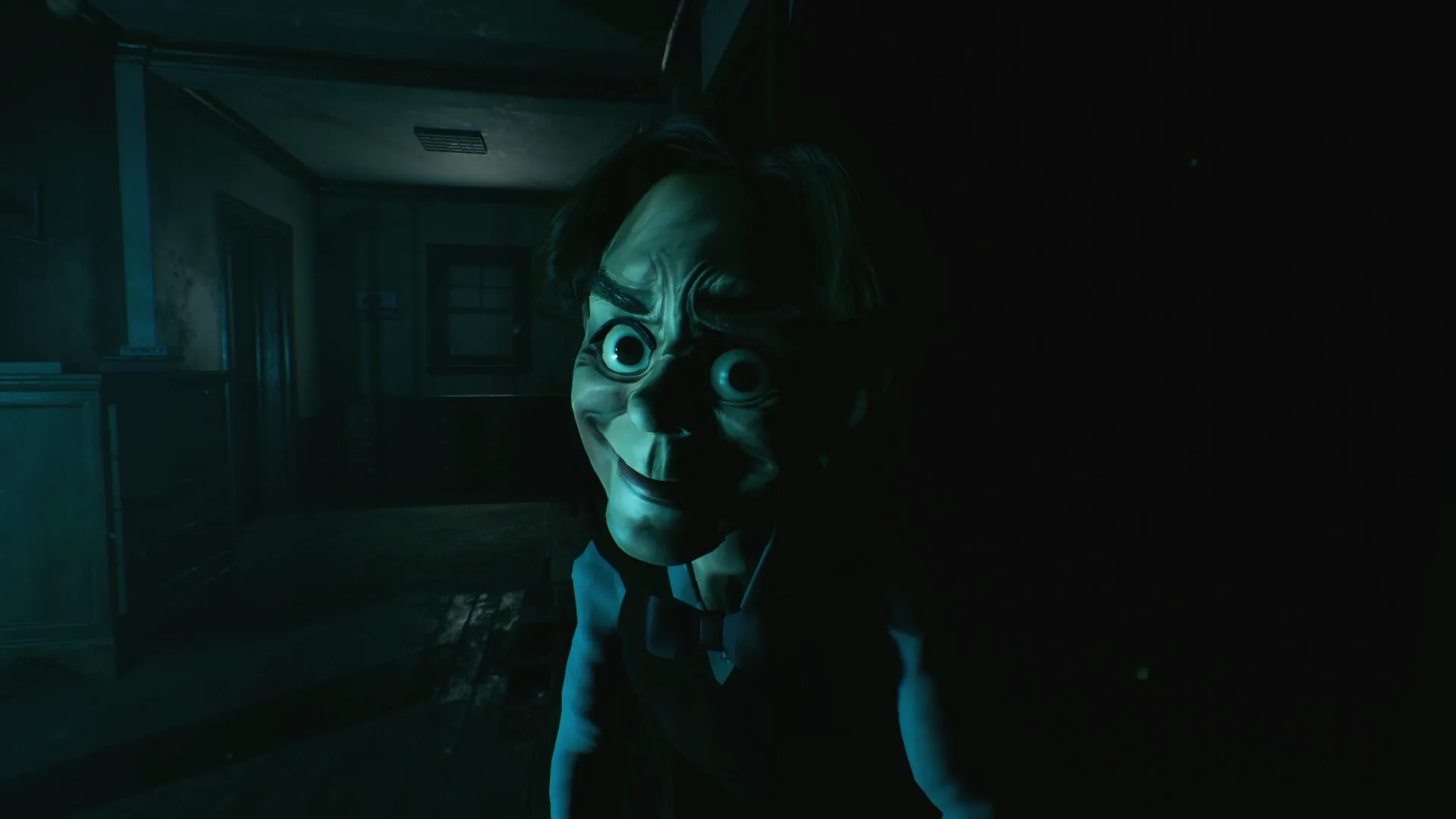 Baptiste: Creepy puppet figure emerging from shadows in dimly lit hallway with wooden floors and paneling.