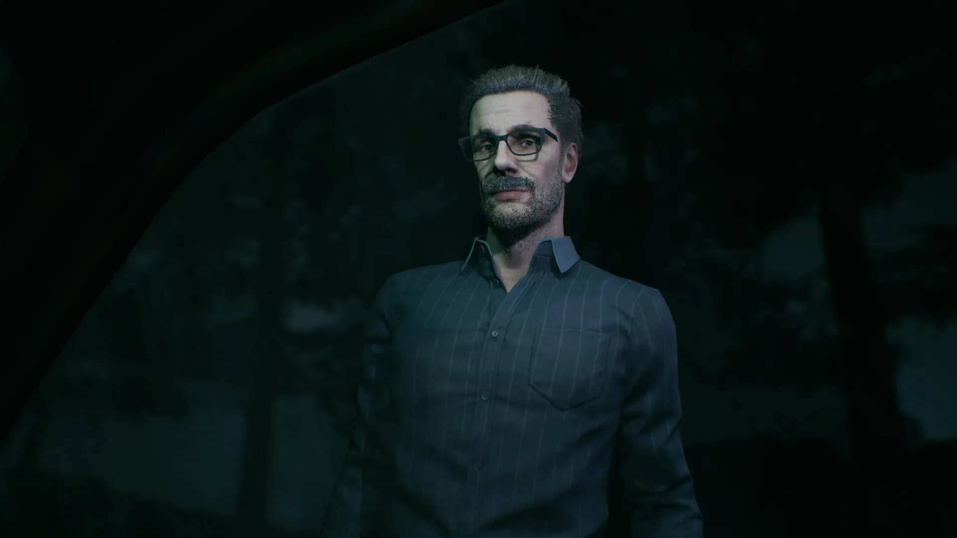 Baptiste: Man with glasses standing outside in dark forest, viewed through a window at night.