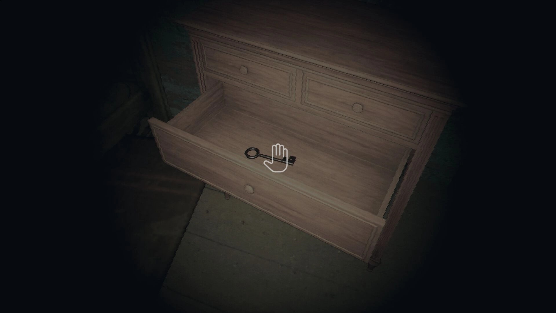 BARABIZNA: A key inside an open drawer highlighted by a cursor in a dimly lit room of the creepy house.