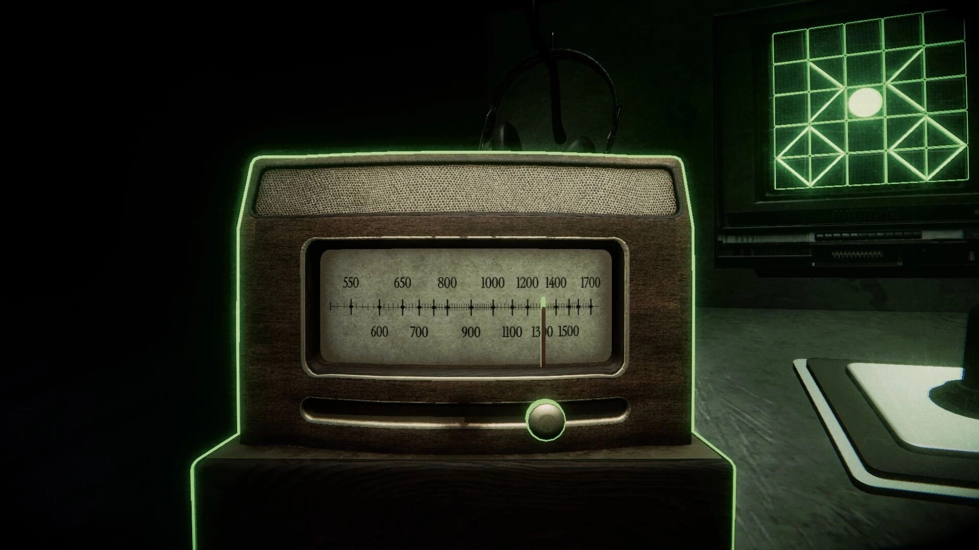 BATHYSPHERE: Close-up of vintage radio dial with green highlight in dim room beside radar monitor.
