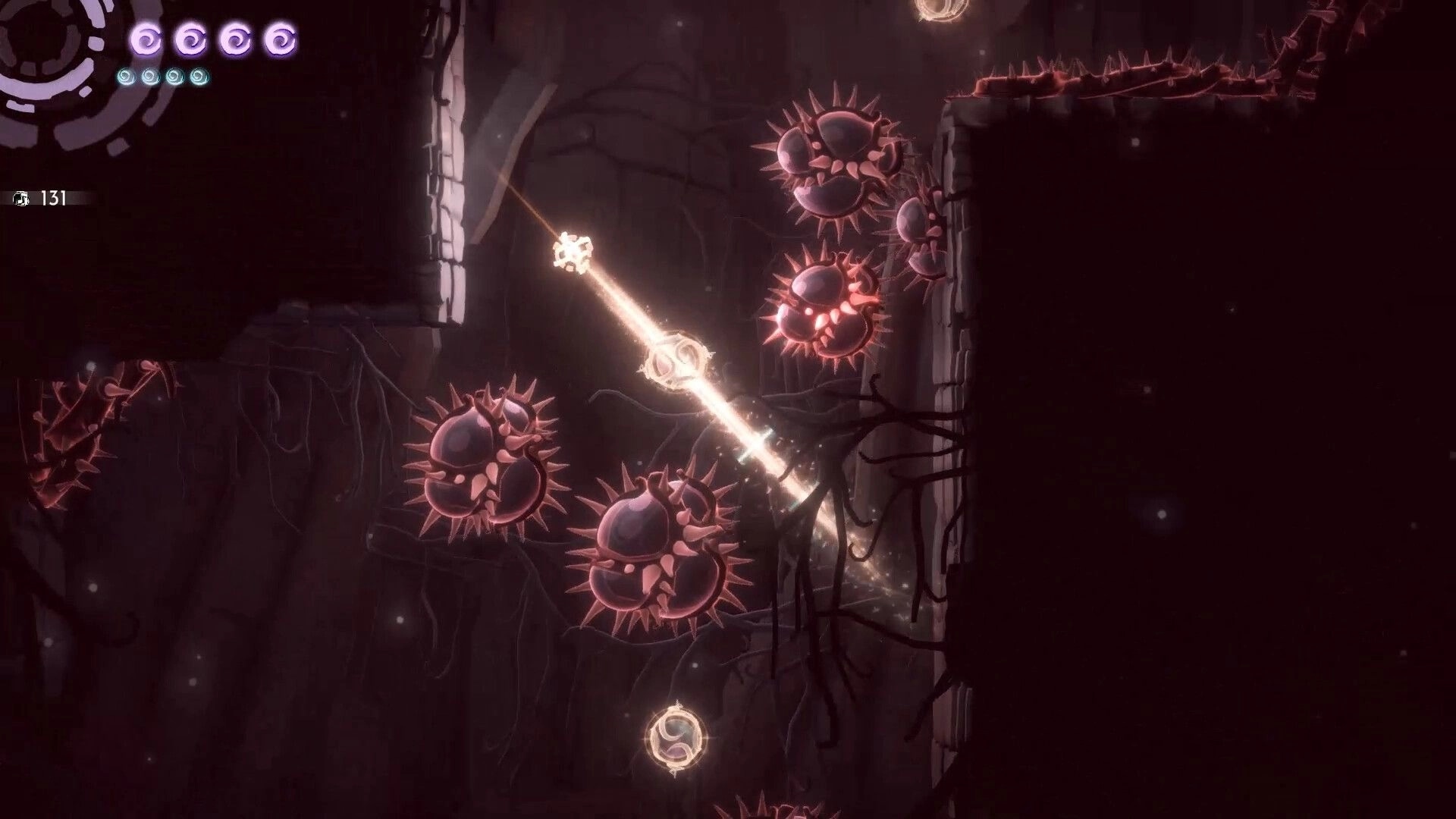 Before I Go: Character navigates spiked obstacles in a dark cavern with glowing orbs and roots.