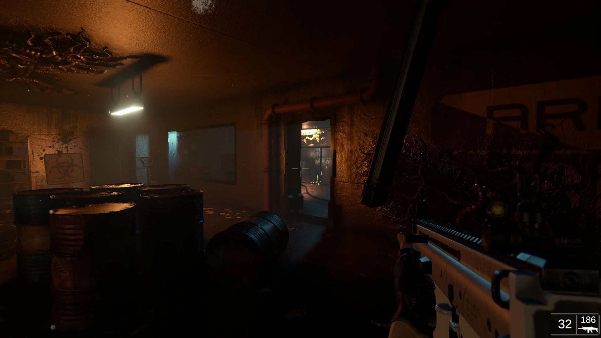 Beneath: Player aiming a weapon in a dimly lit corridor with barrels and biohazard warning signs.
