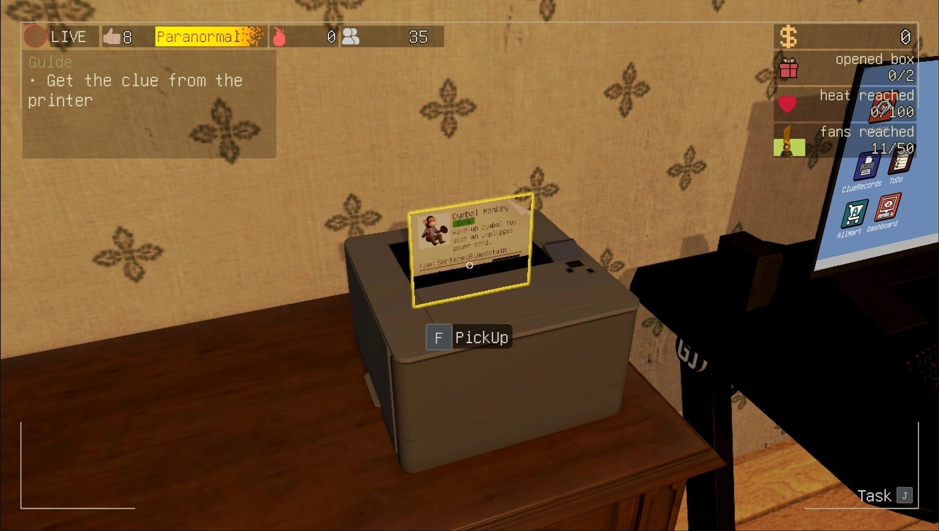 bet you won’t: picking up a clue card from a printer on a desk in a livestream unboxing room.
