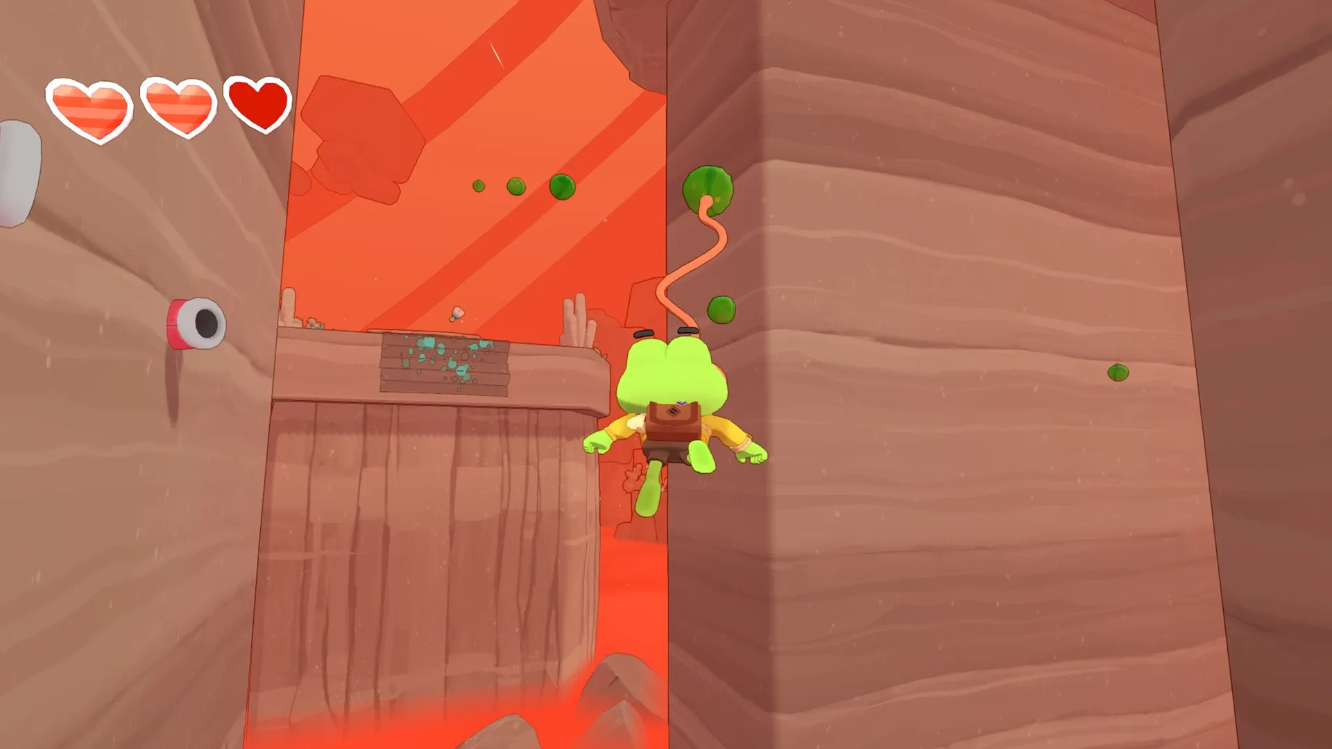 Big Hops: Frog character swinging with tongue in a desert canyon, two hearts shown in the top left HUD.